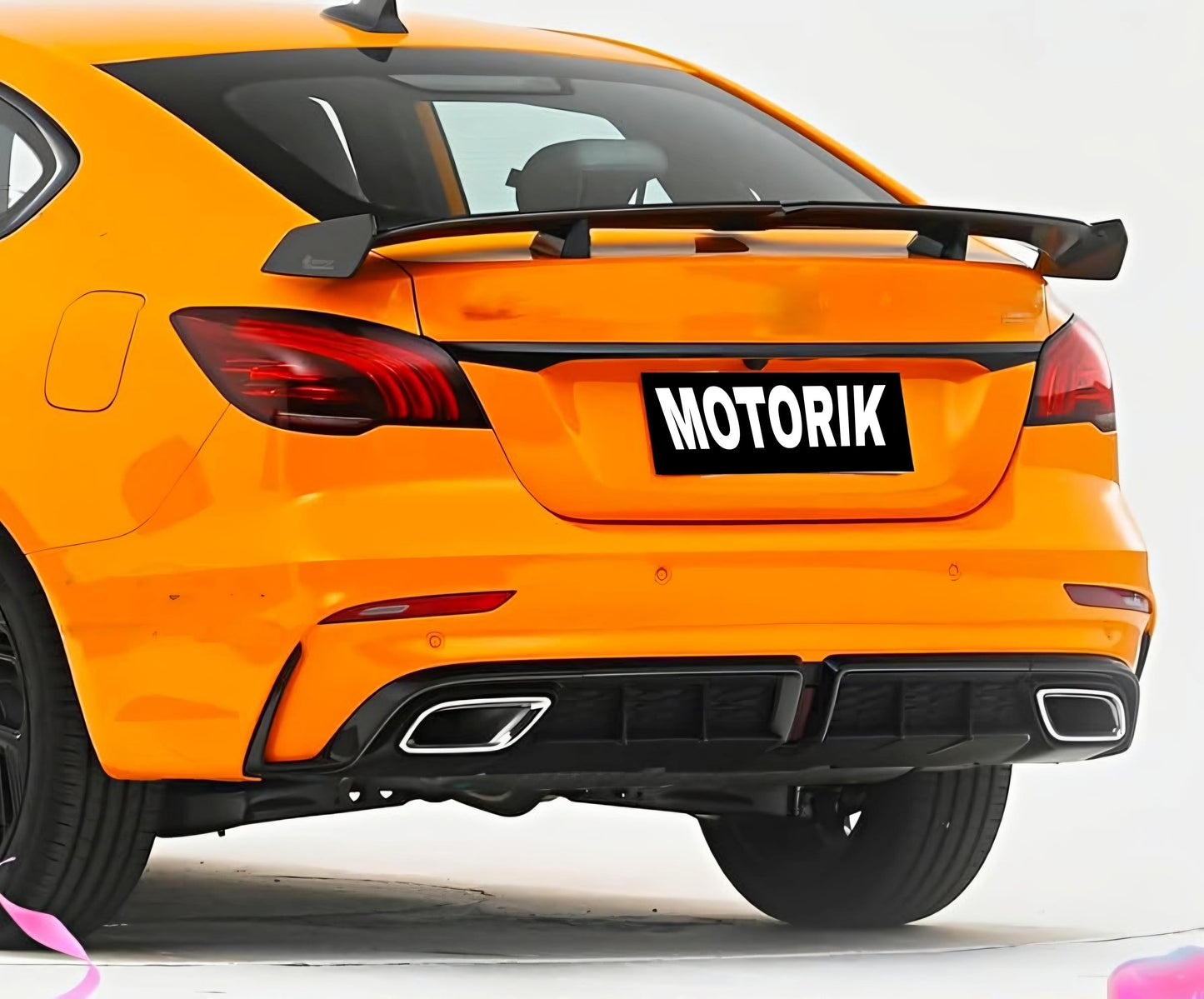 Motorik Detailing ABS quality GT spoilers on a bright orange car for enhanced aerodynamics