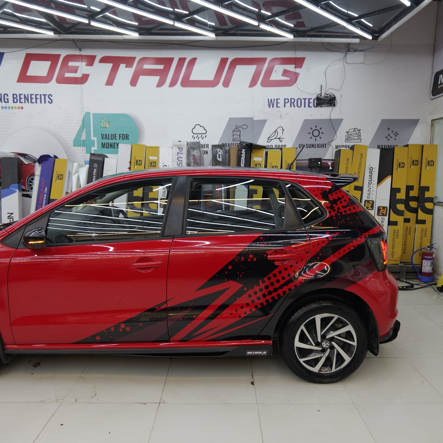 Stylish red hatchback with abstract Hatchback car side graphics for a unique look