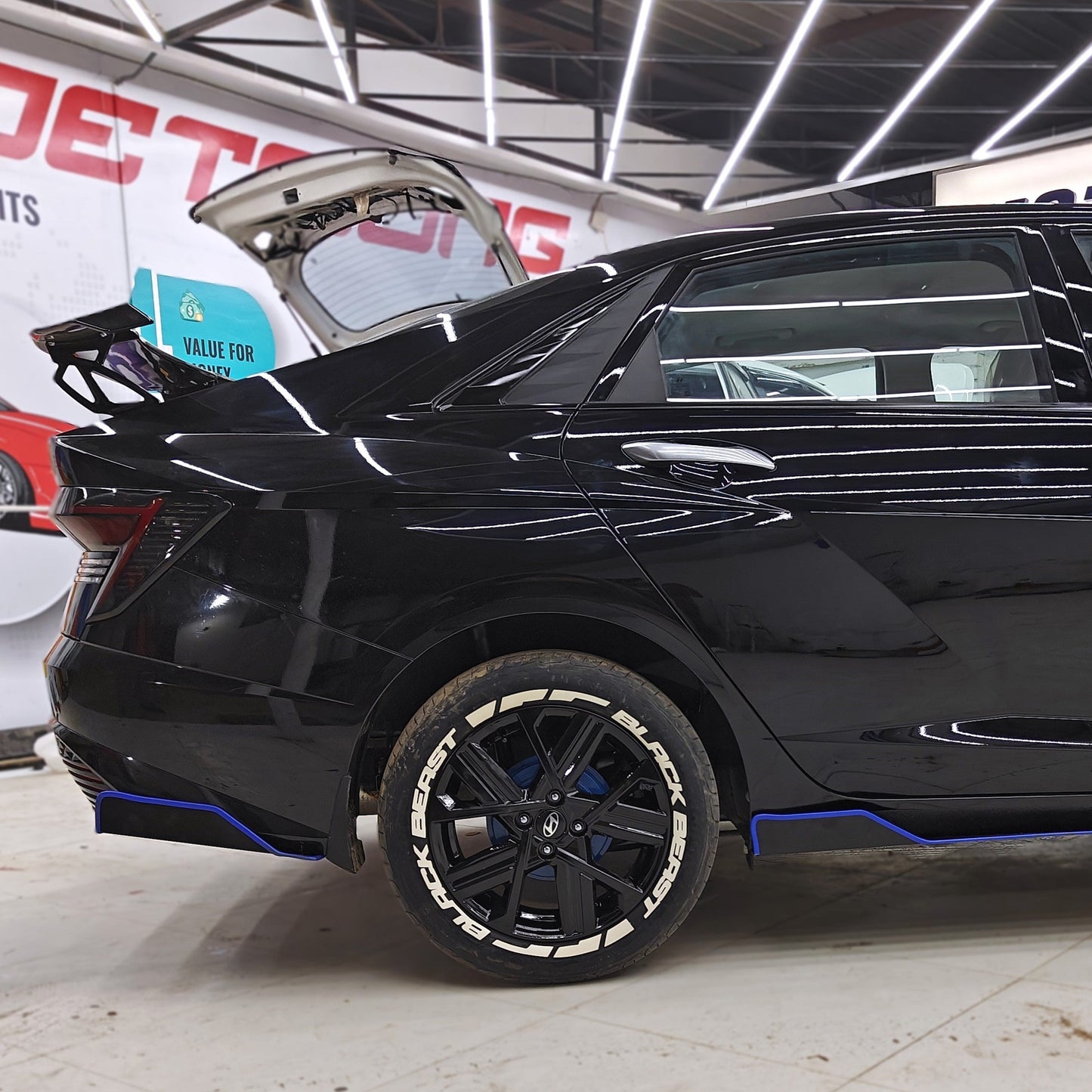Black car featuring Black Beast tyre stickers for a stylish and aggressive look