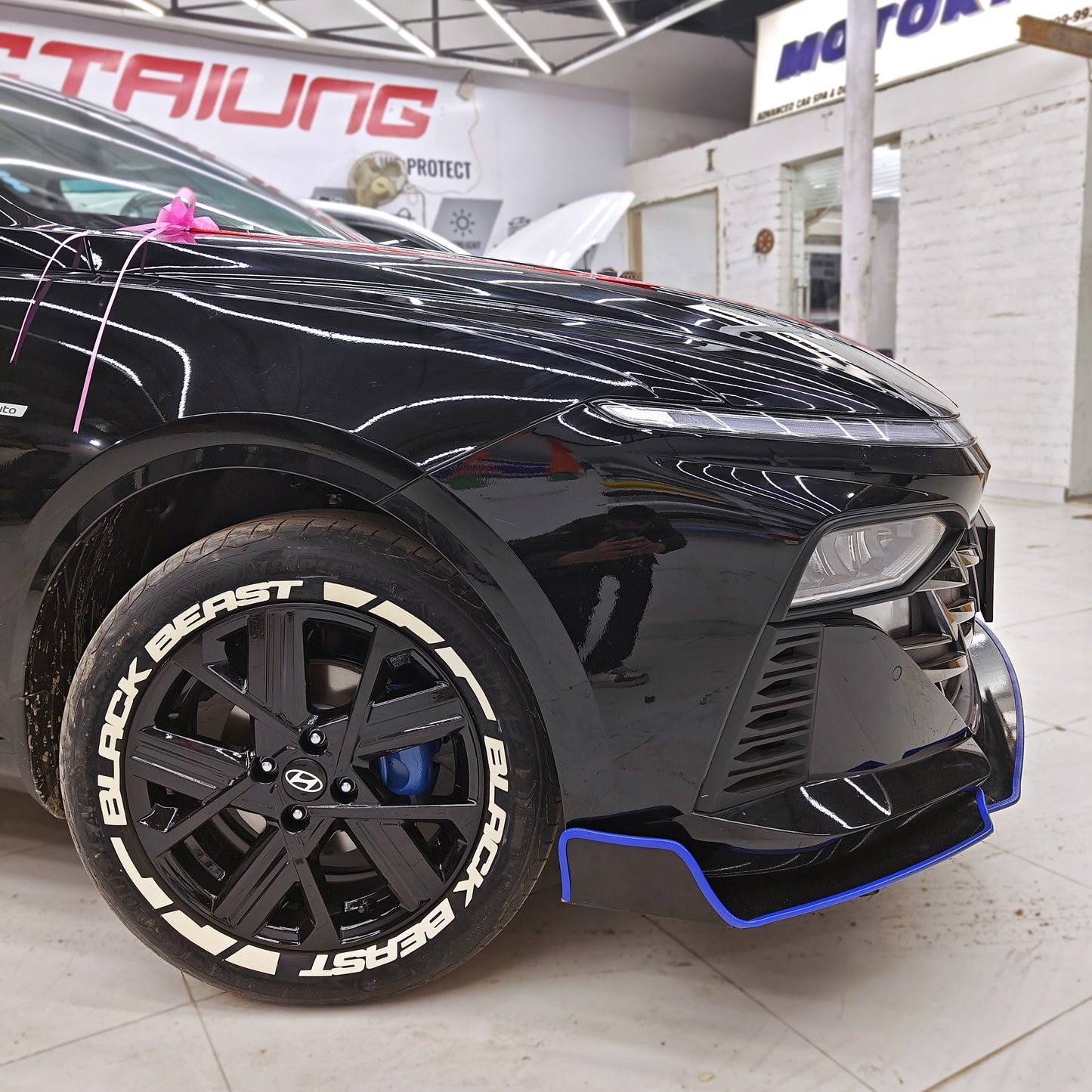 Black Beast tyre Stickers on stylish black alloy wheels of a sporty car at Motorik Detailing studio