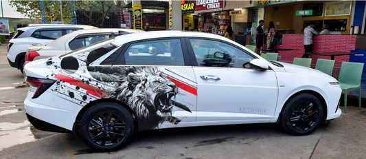 Sedan car graphics featuring a striking lion design on a white Motorik Detailing vehicle