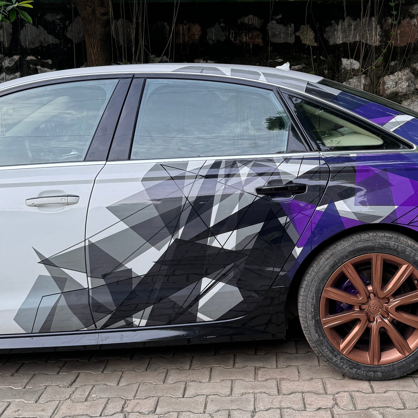 Stylish sedan with Motorik Detailing car side and rear graphics decals in modern geometric design