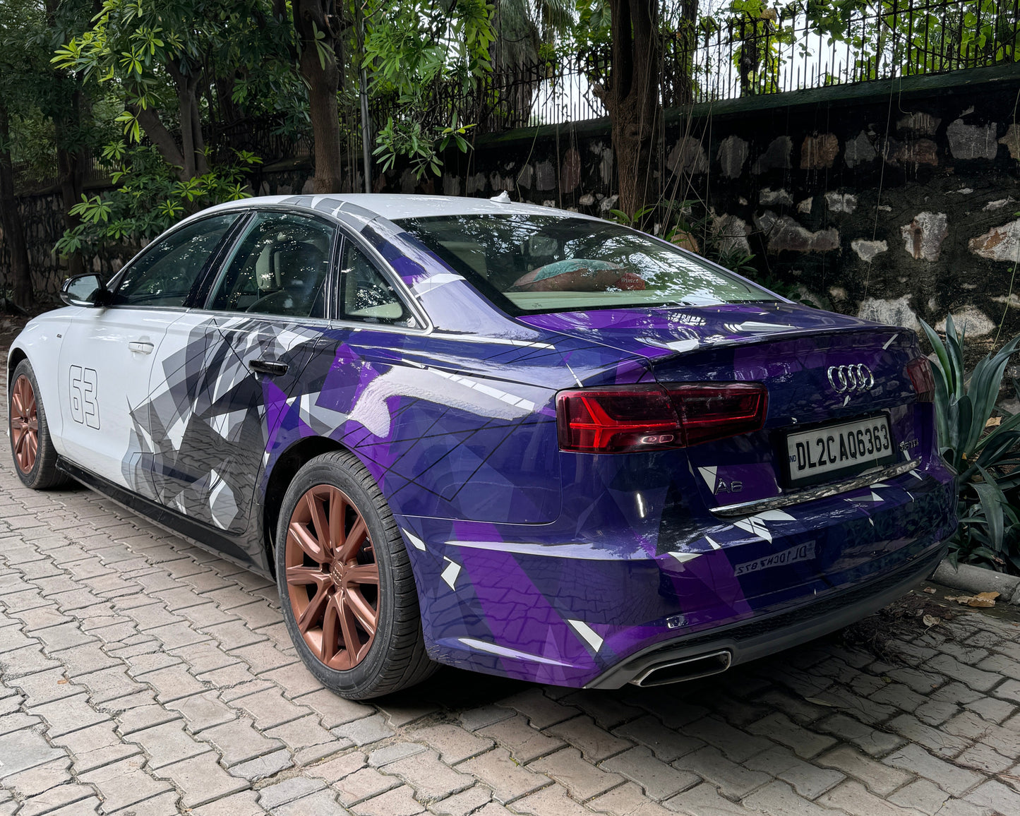 Stylish sedan with purple and black car side and rear graphics decals enhancing its modern look