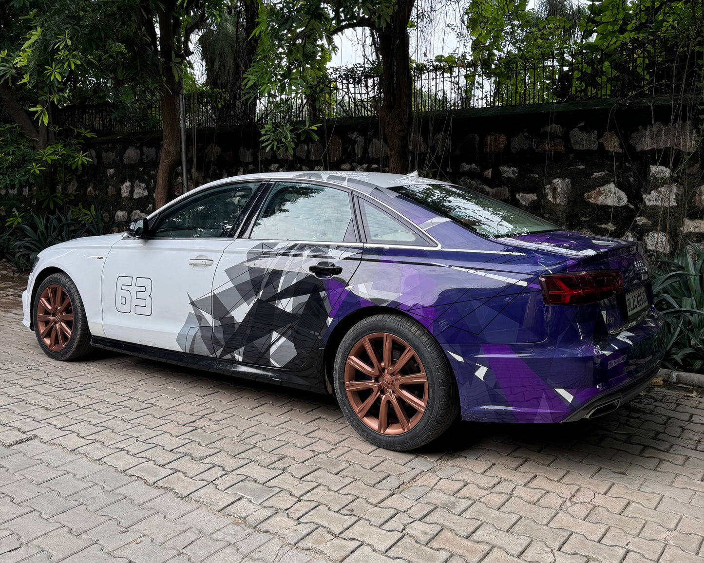 Sedan car with stylish purple car side and rear graphics decals showcasing a modern design