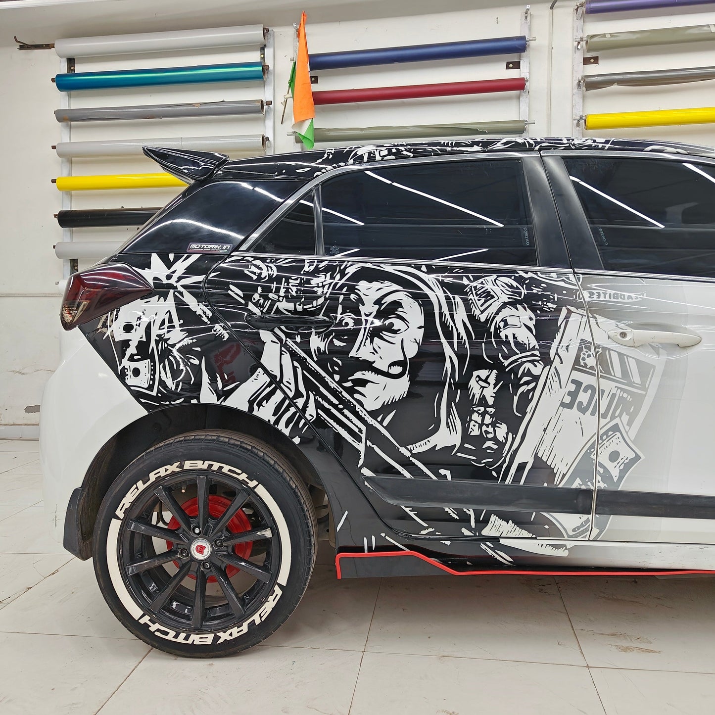 BIT*CH RELAX(W) tyre sticker on a customized car with unique artwork and sport wheels