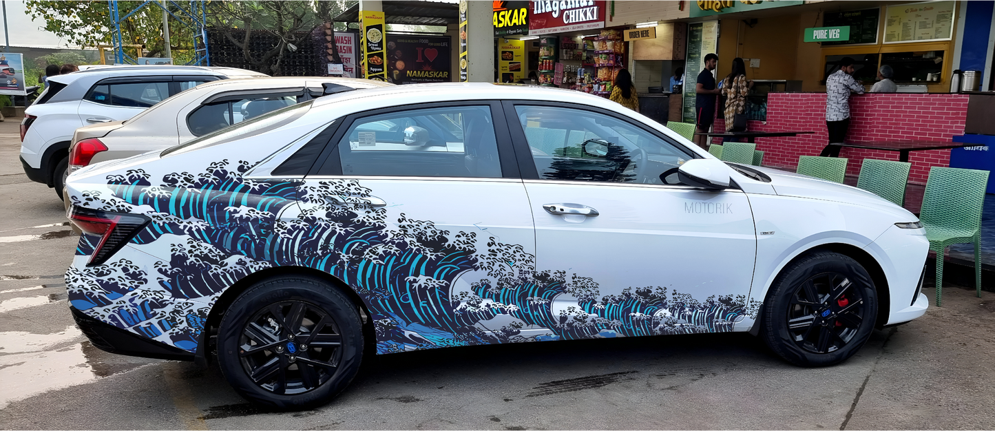 Sedan car featuring ocean wave car graphics by Motorik Detailing, showcasing a vibrant design