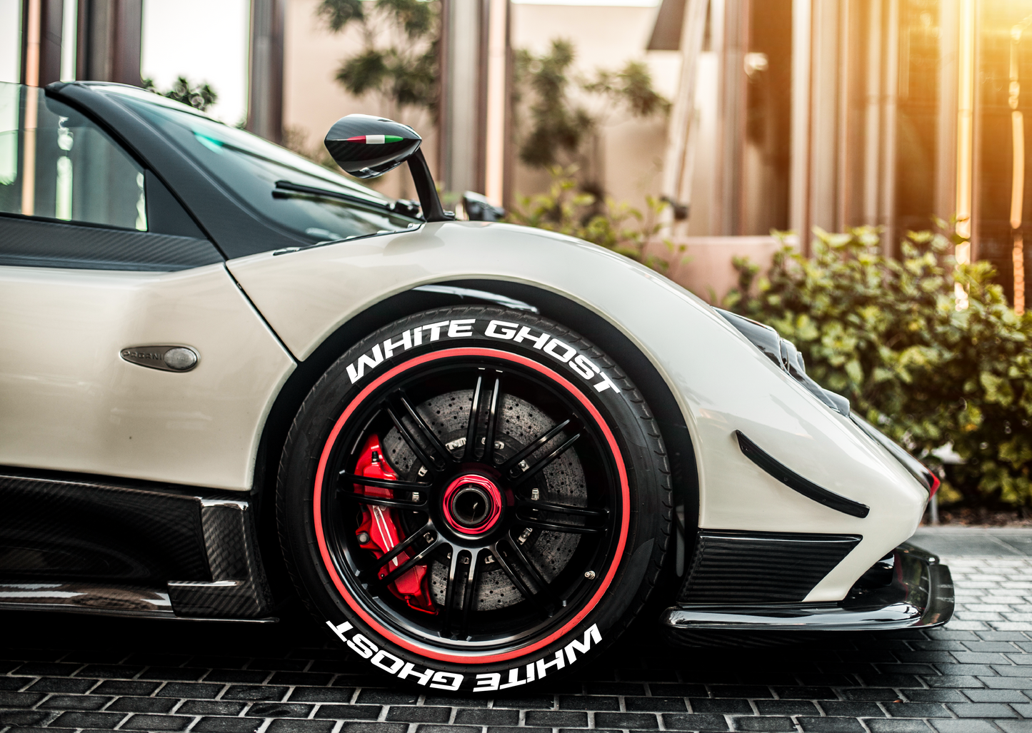 Custom tire stickers set on a high-performance sports car with sleek design and bold lettering