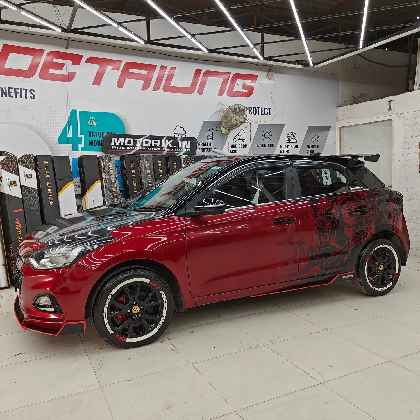 GT Racing tire stickers on a red car with stylish design from Motorik Detailing