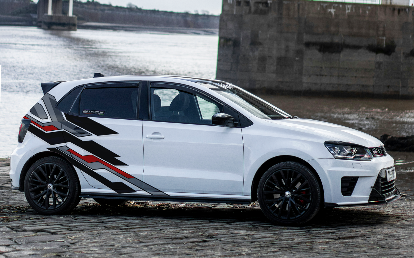 Stylish hatchback car abstract side graphics in black and red on a modern hatchback vehicle