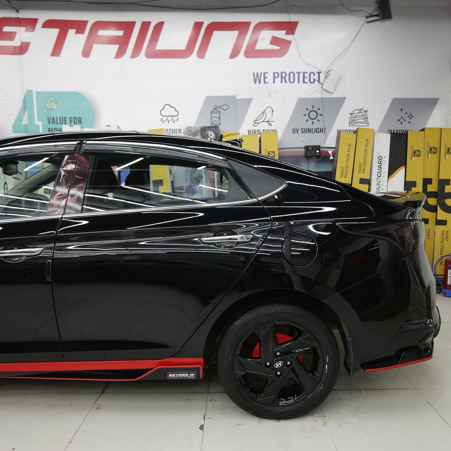 Black Hyundai with Motorik Detailing metal splitters for Hyundai showcasing sleek design and performance