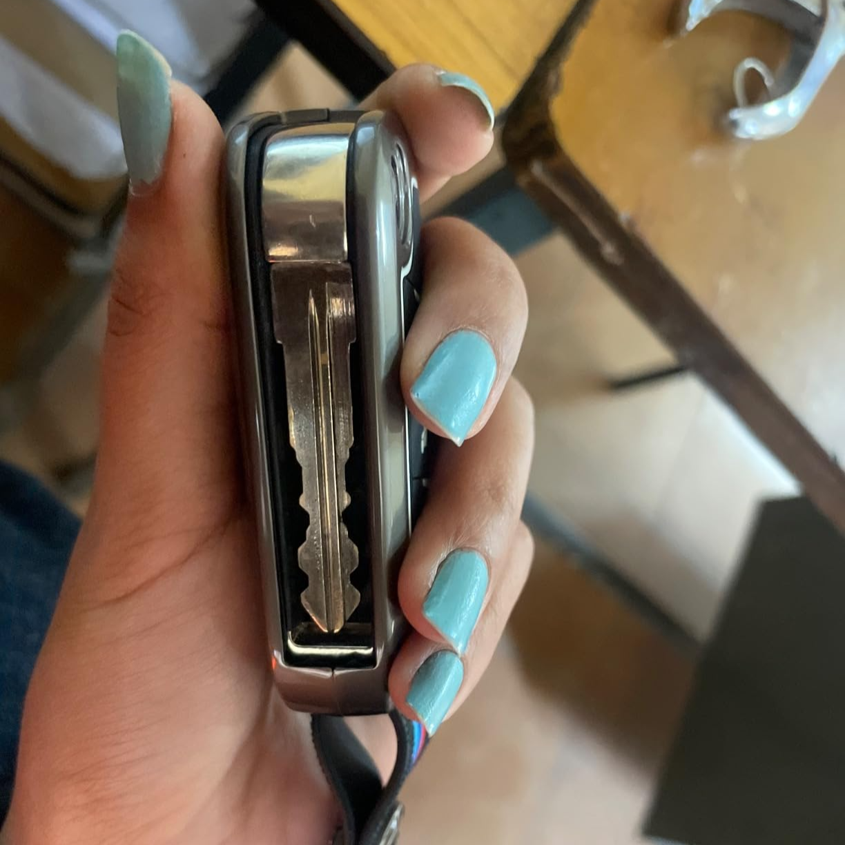 Metal car key cover Mahindra securely protecting the key with a sleek design in hand