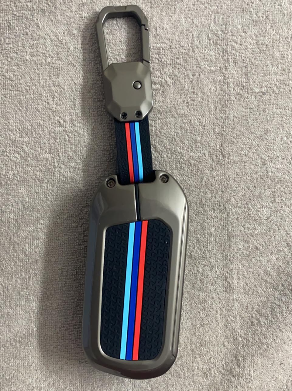 Stylish metal car key cover Mahindra with a durable grip and colorful striped design