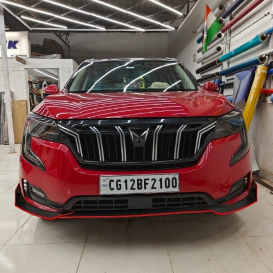 Red Mahindra XUV with stylish skirtings from Motorik Detailing showcasing a sleek design