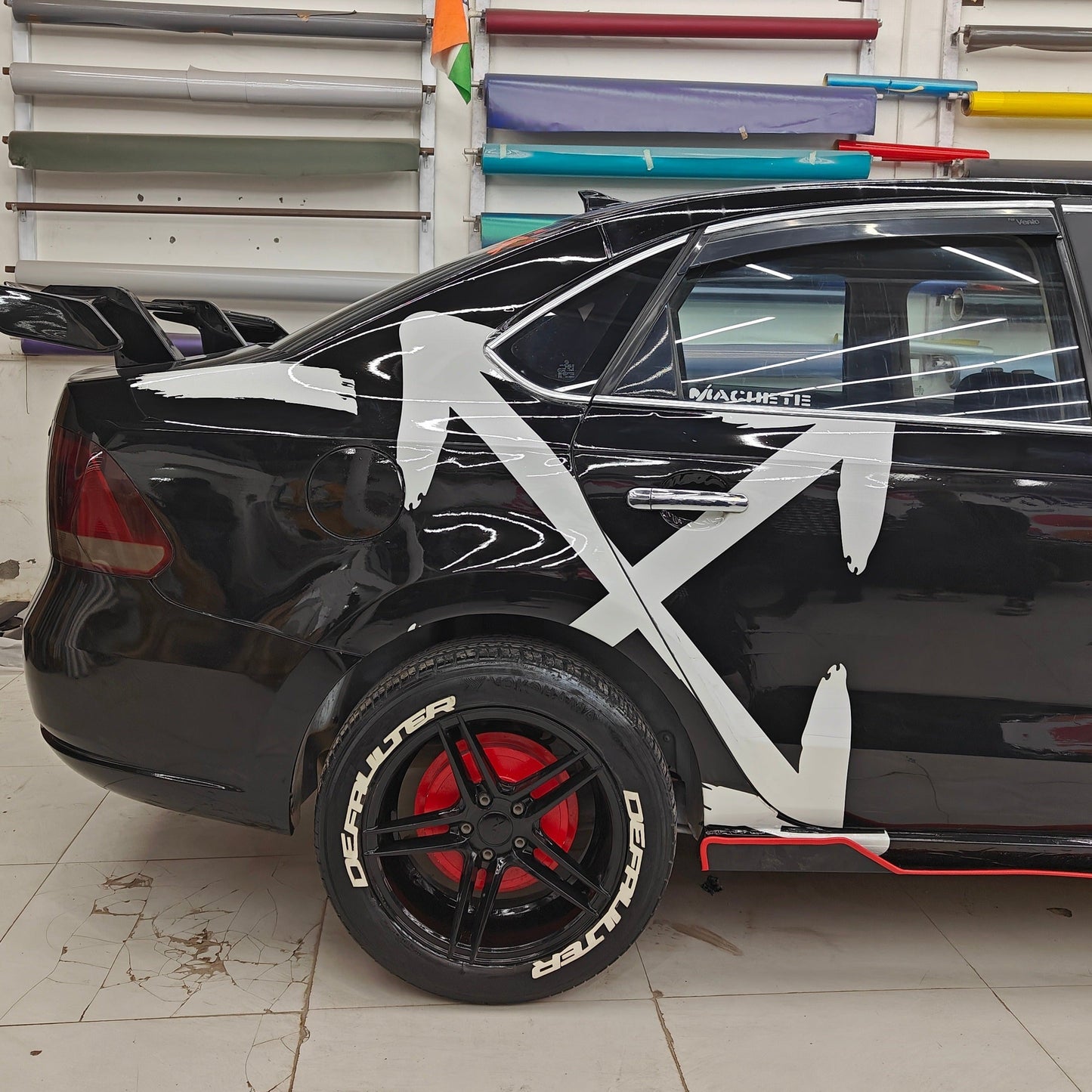 Defaulter tyre sticker on a black car with red accents and bold graphic design for a unique look