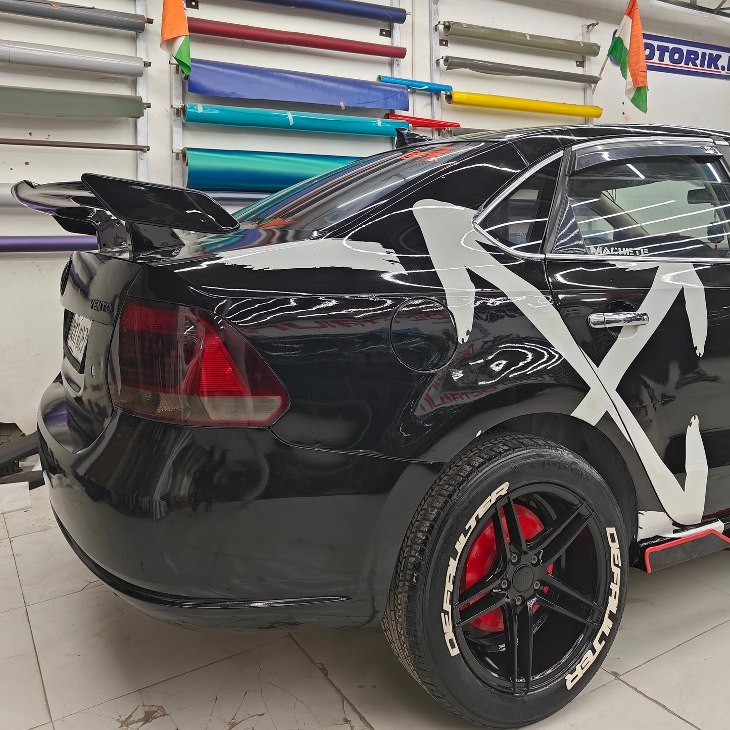 Defaulter tyre sticker on a black car with a stylish design and red accents for automotive enthusiasts