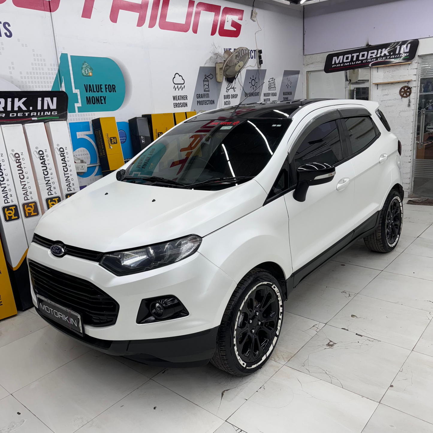 White Ford SUV with DEFAULTER Tyre Stickers and sleek black rims for a stylish look