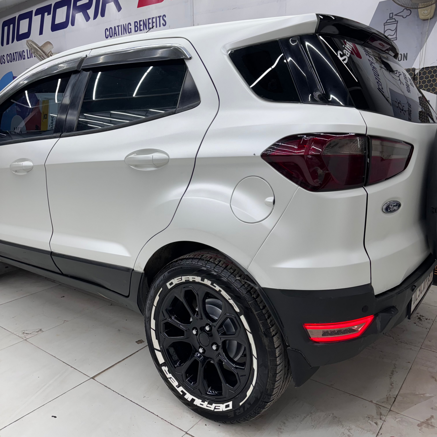 Ford SUV with DEFAULTER Tyre Stickers on black wheels, showcasing a stylish design.