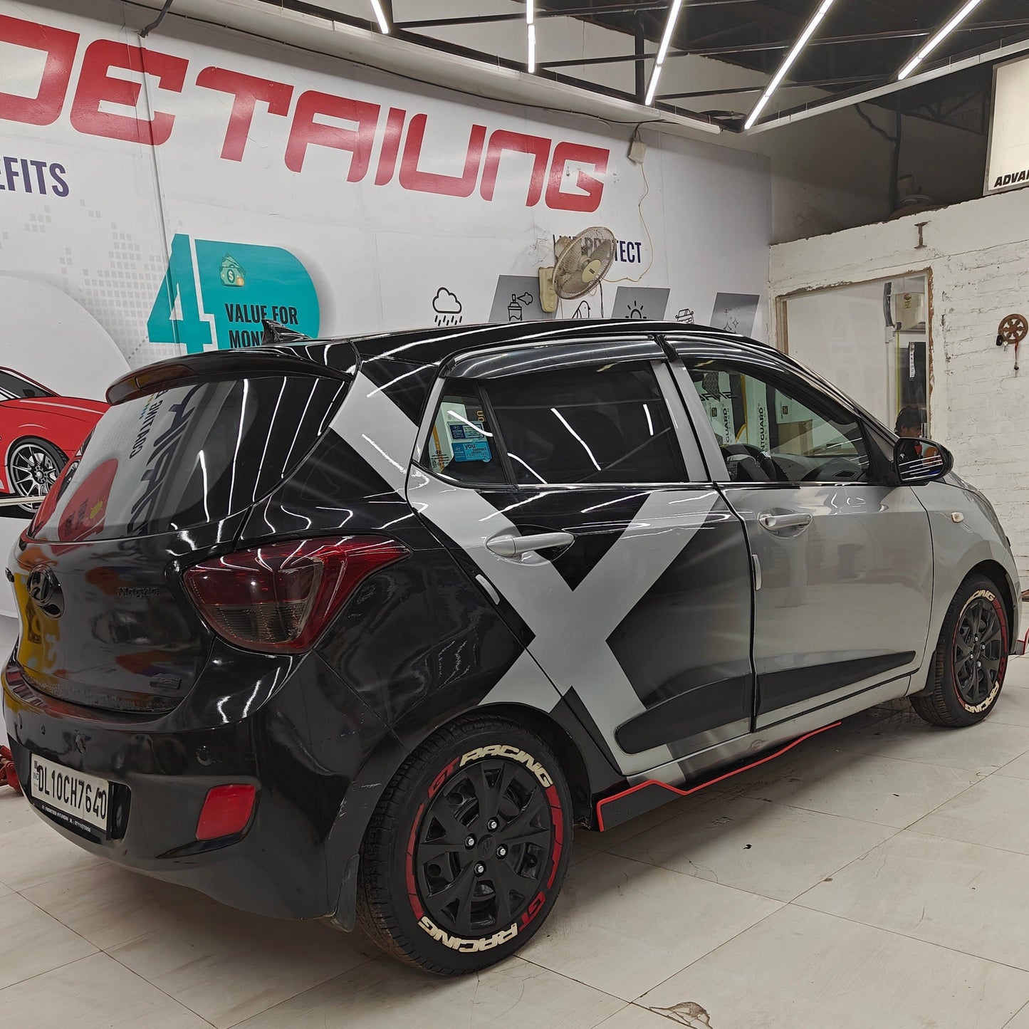 Car with GT racing tire Stickers with Gun Strips showcasing modern design and detailing services