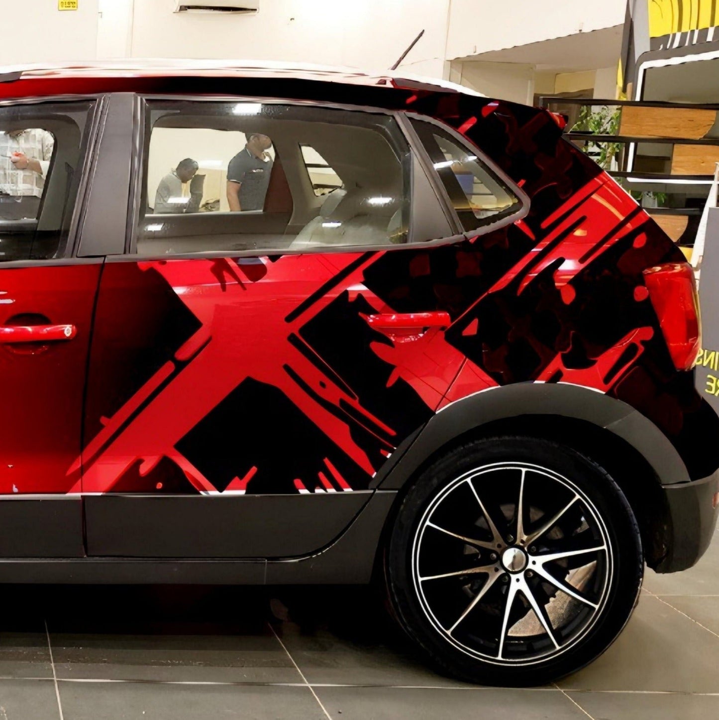 Motorik Multi-X graphics applied on a car side with bold red and black design elements for enhanced aesthetics