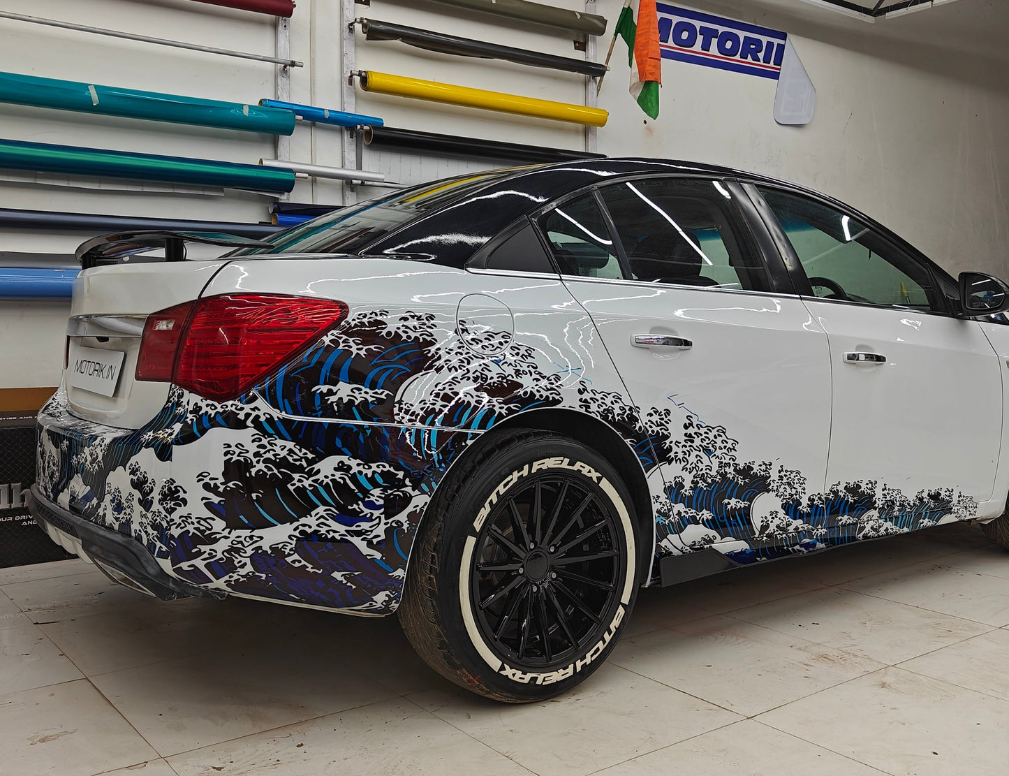 Sedan car featuring ocean theme car sticker with wave design on the side for a vibrant look