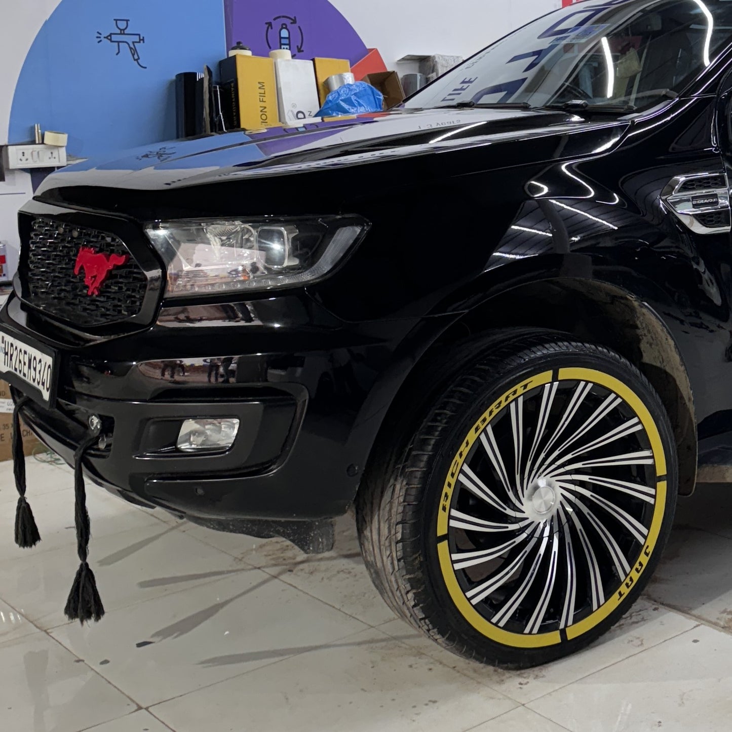 Black truck with custom wheels featuring a Permanent Tyre Stickers Kit for a bold look