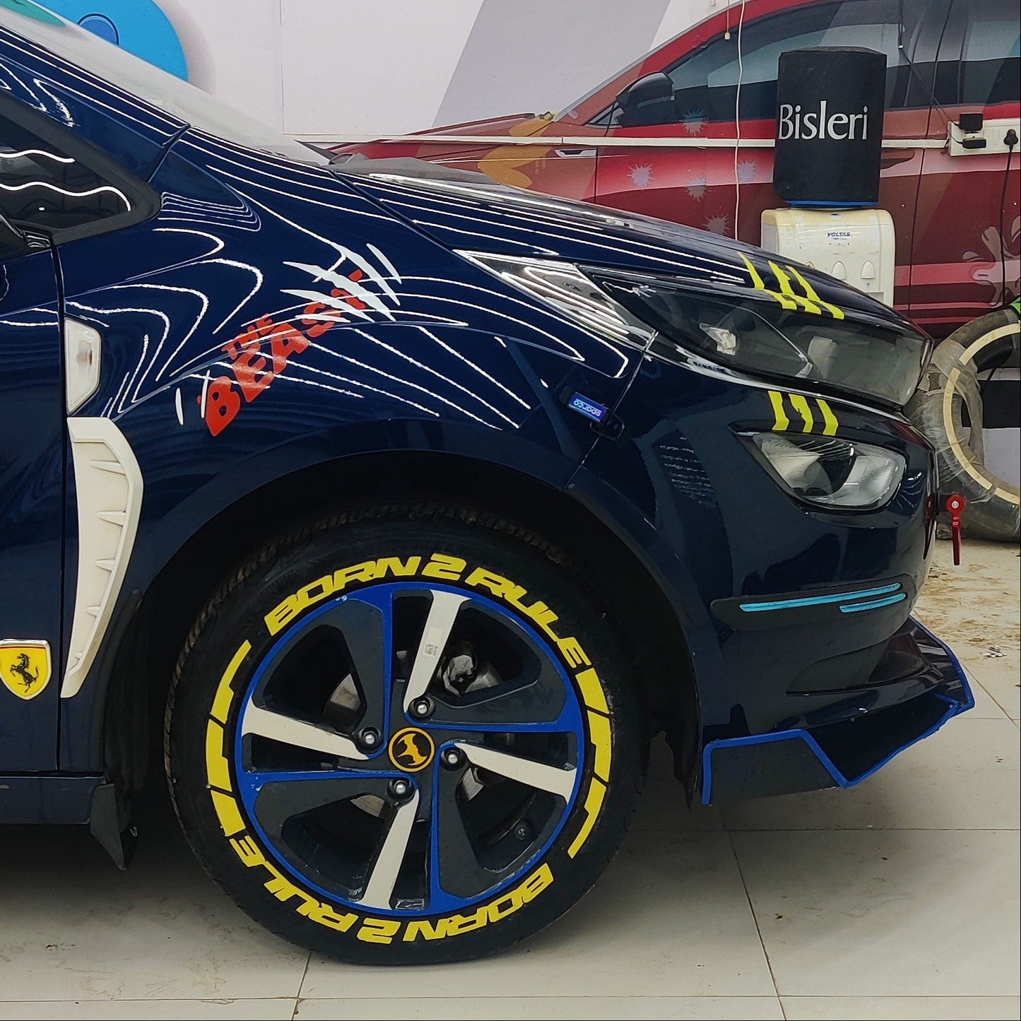 Permanent Tyre Stickers Kit featuring bold yellow designs on blue alloy wheels for a unique car look
