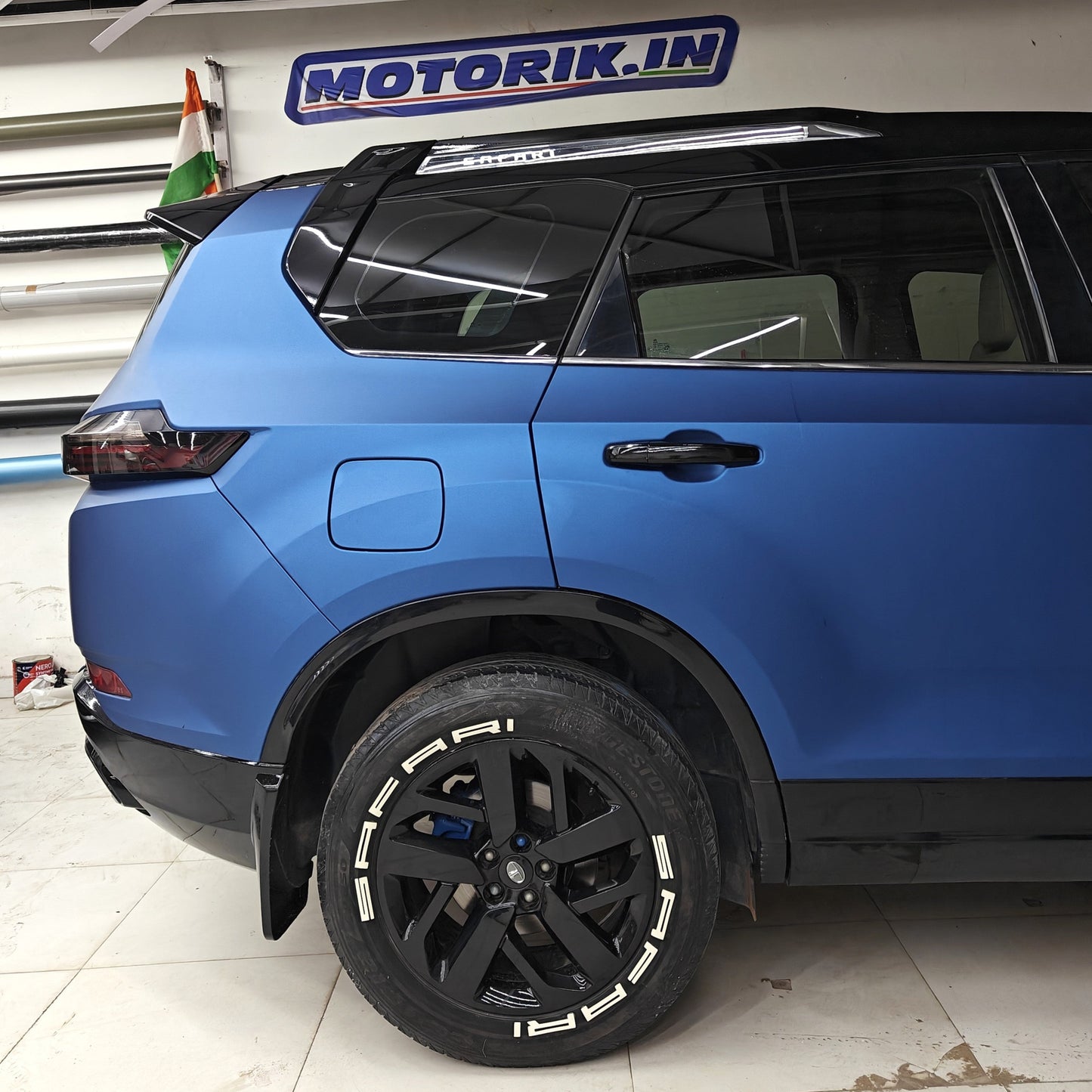 Permanent Tyre Stickers Kit applied to stylish black alloy wheels of a blue SUV