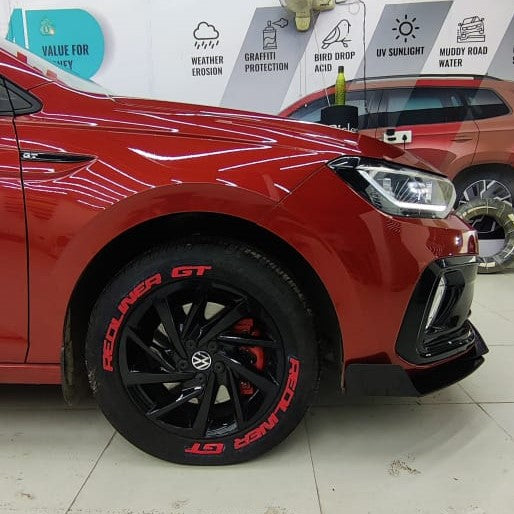 Red car with black wheels featuring Permanent Tyre Stickers Kit for enhanced visual appeal