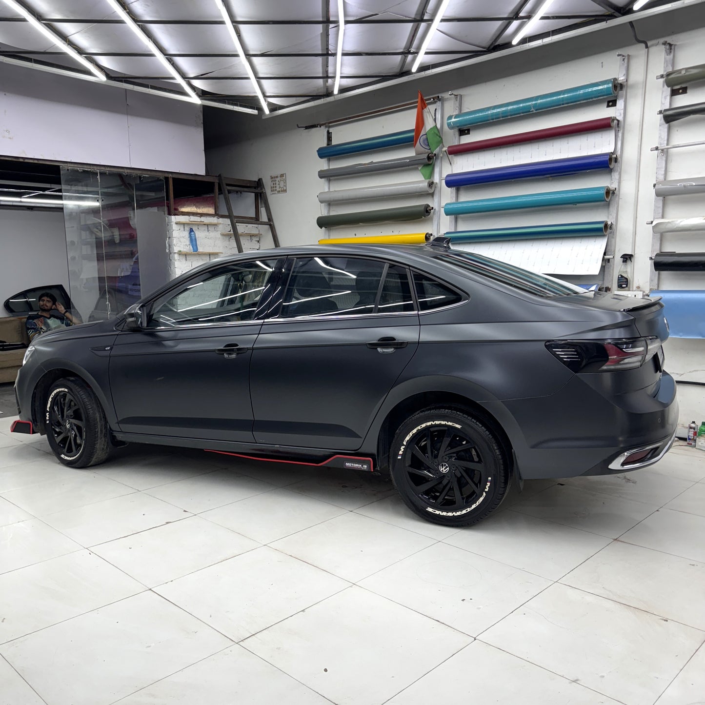 Motorik Detailing Volkswagen skirting accessories 5 pcs installed on a sleek black car in a detailing studio