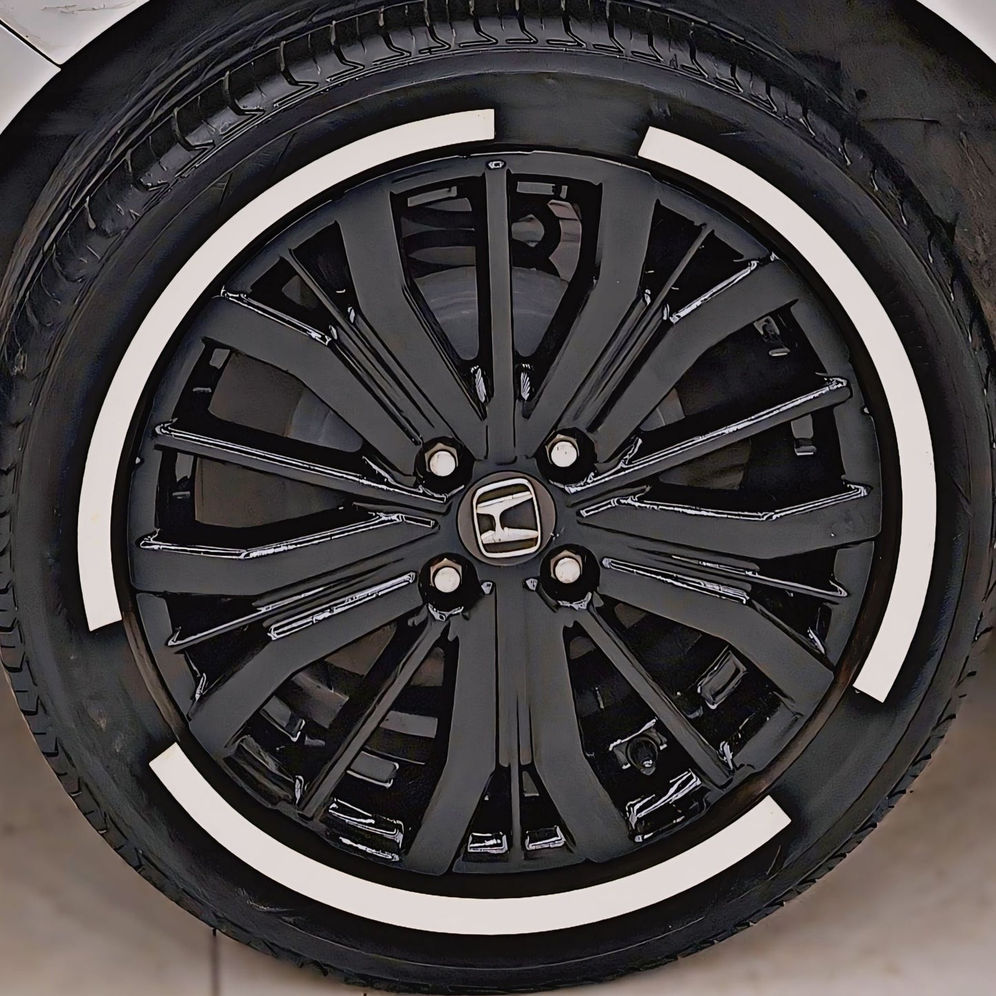 Black alloy wheel with permanent rubber tyre stickers enhancing the stylish look for vehicles