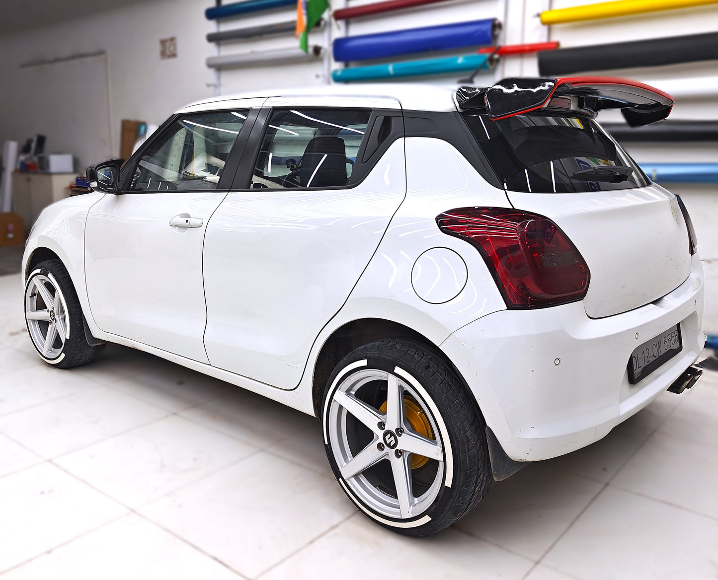 Stylish white car with permanent rubber tyre stickers and bright alloy wheels for enhanced appearance