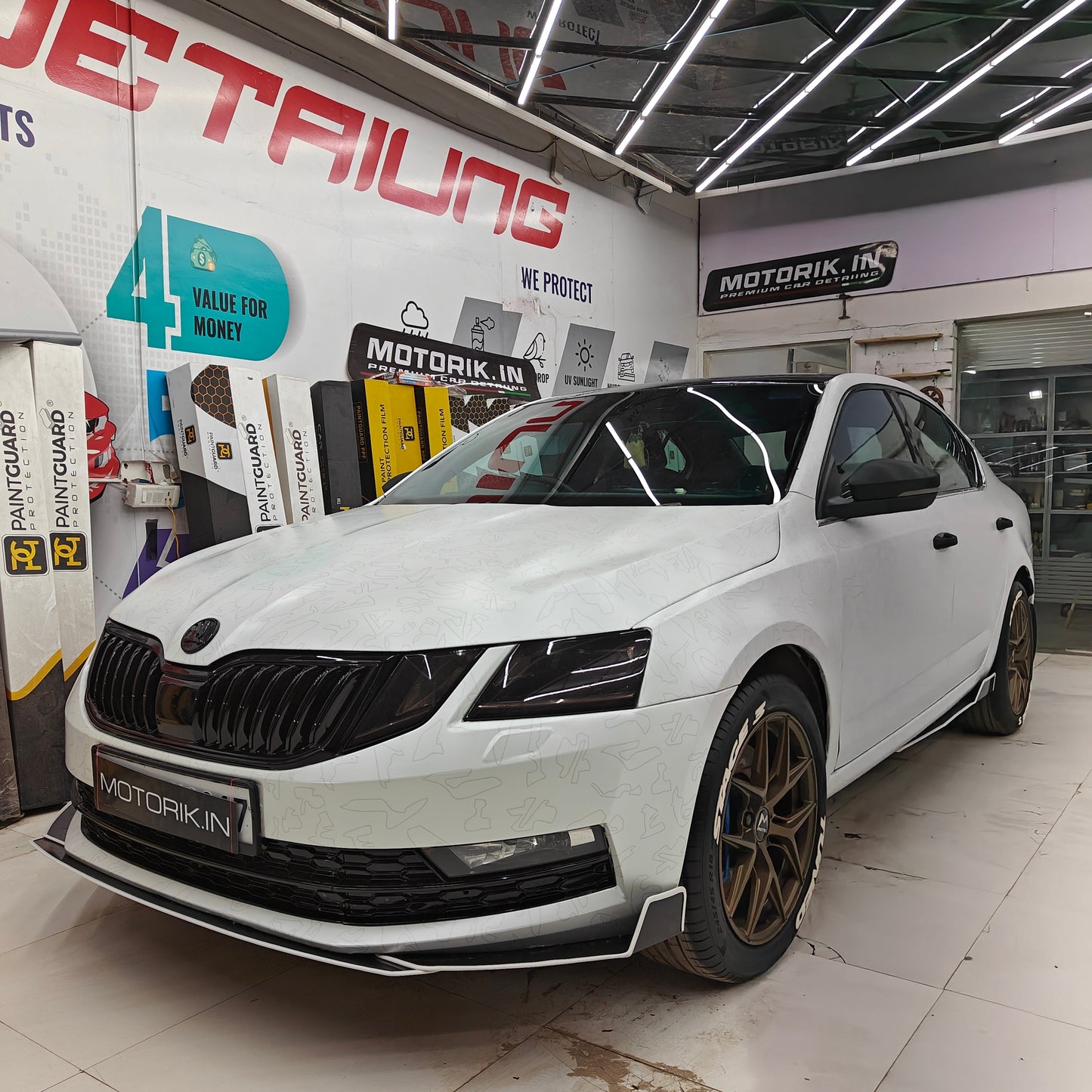 Skoda bumper protectors set displayed on a sleek white Skoda car at Motorik Detailing showroom