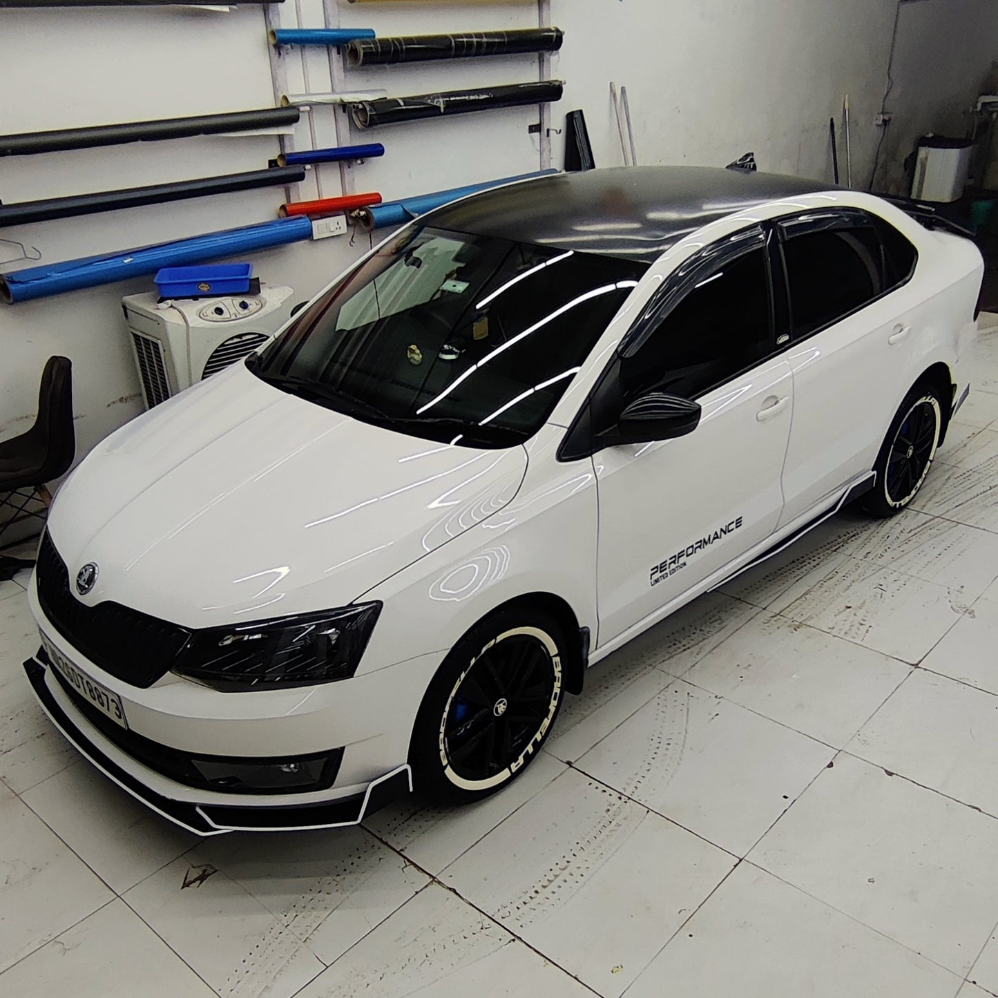 Skoda bumper protectors set installed on a modified white Skoda sedan in a detailing garage