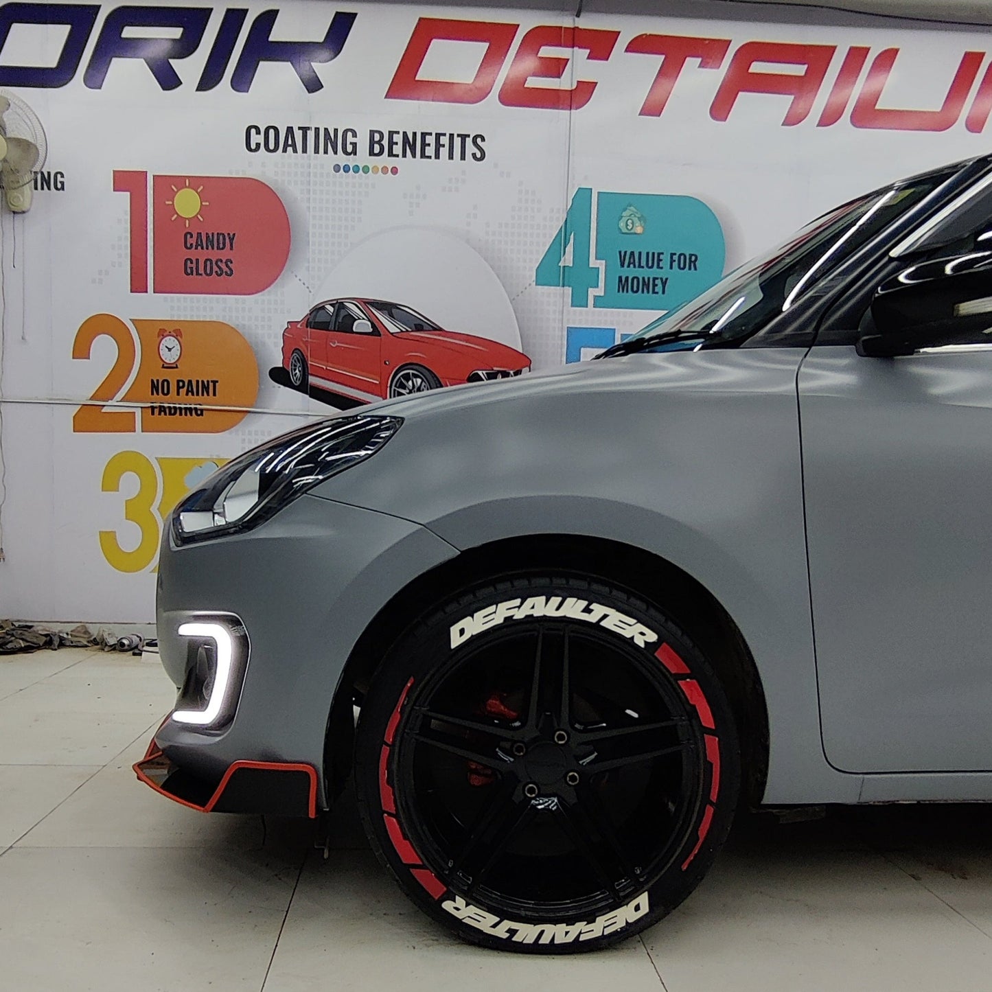 Suzuki front and side splitters installed on a sleek gray Suzuki car, showcasing a sporty design