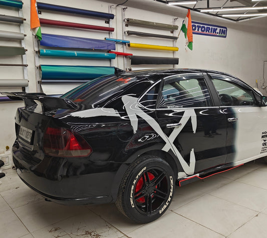 ARROW X car graphics on a black sedan, showcasing a sleek design with bold white elements