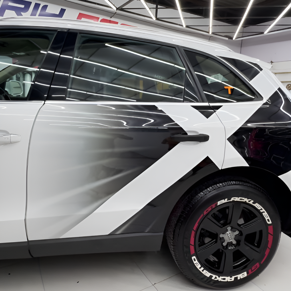 Stylish Big x custom car graphic wraps on a sleek SUV in black and white design