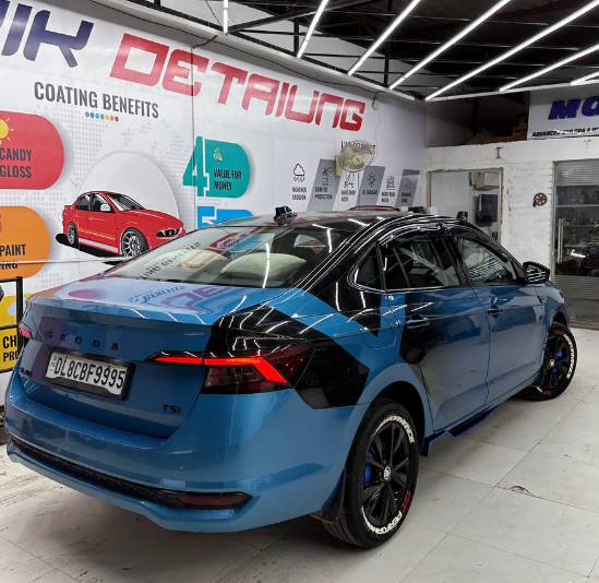 Blue car with Big x custom car graphic wraps showcased at Motorik Detailing shop