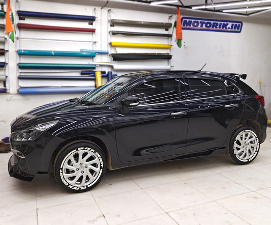 Black car with BlackBeast rubber tire stickers accentuating stylish white rims and sleek design