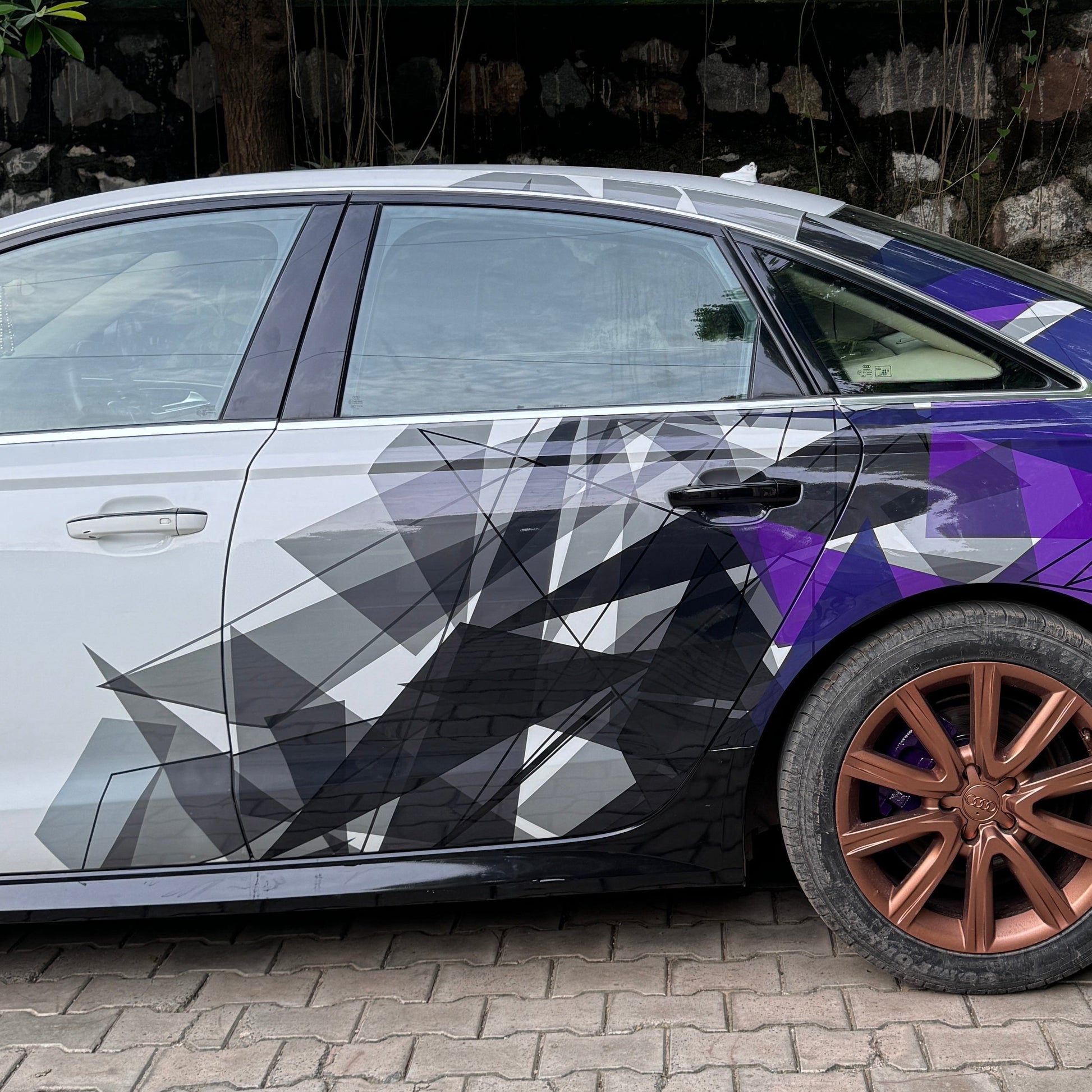 Stylish sedan with Motorik Detailing car side and rear graphics decals in modern geometric design