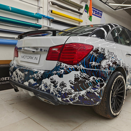Ocean theme car sticker on a sedan with wave graphics and custom detailing by Motorik Detailing