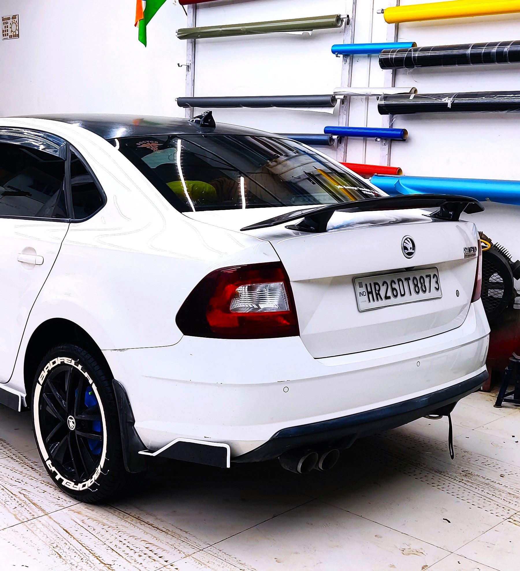 White car with a sleek design featuring a premium car spoiler for enhanced aerodynamics