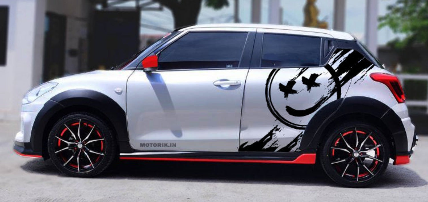 Stylish hatchback car with smile car graphic design, featuring bold black accents on a silver finish