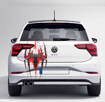Volkswagen car with splatter art car decals featuring a striking spider design on the rear